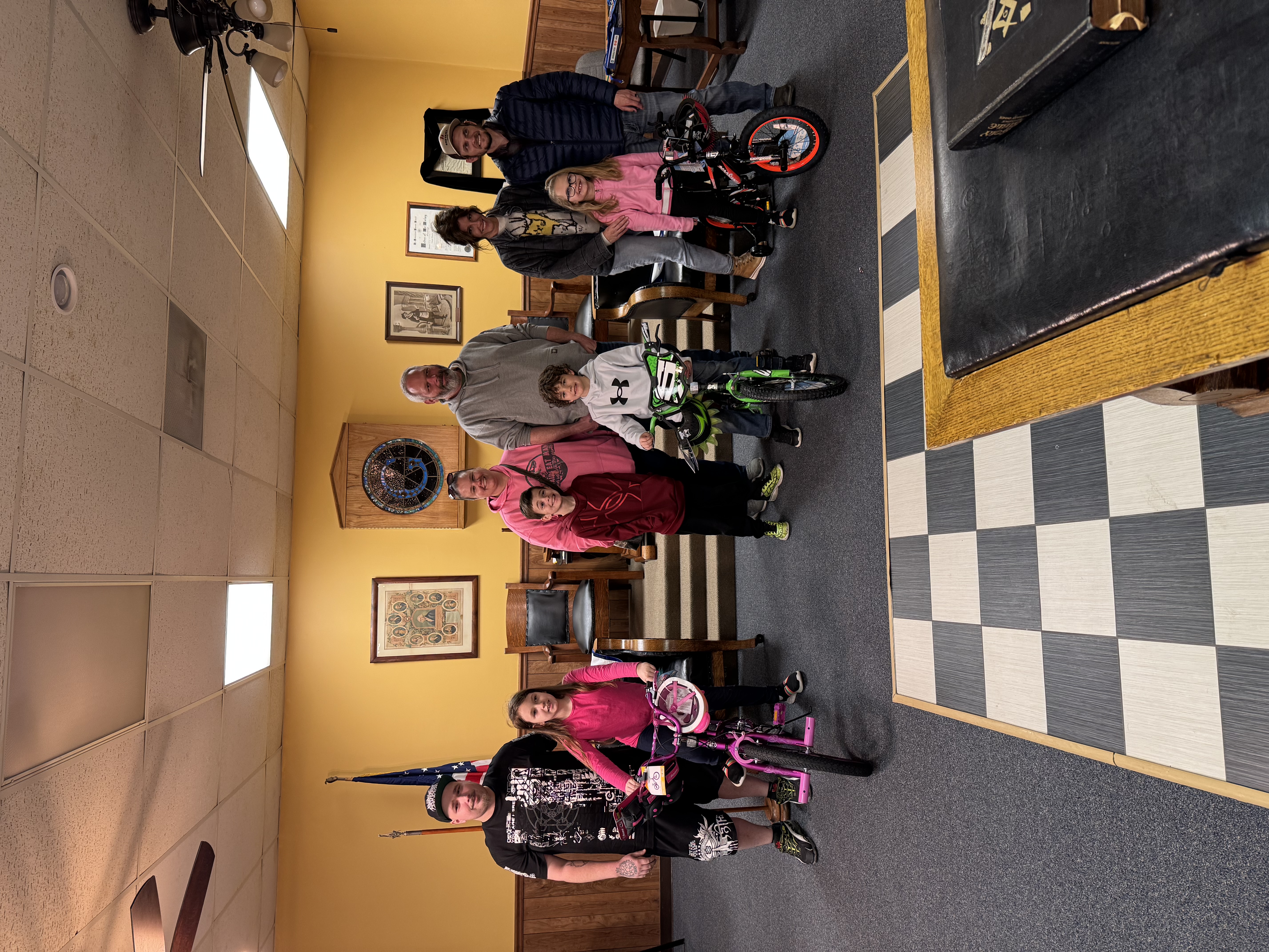 A Picture of the three bike winners from the three schools and their families