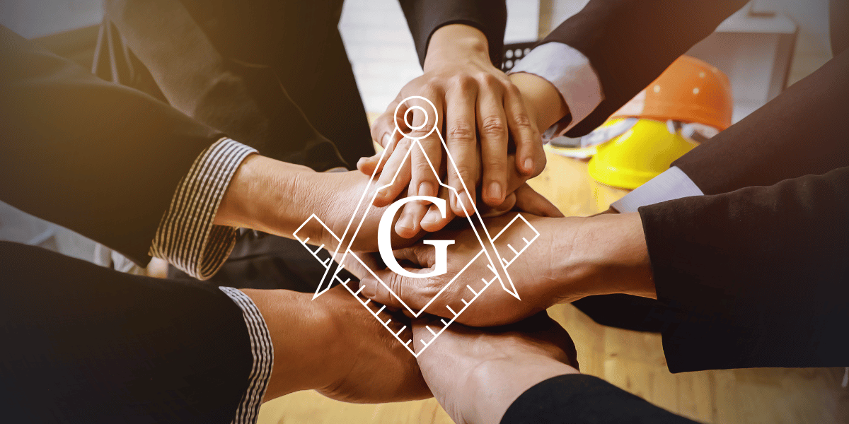 Picture of hands, one on top of another with the Masonic Square and Compass with G in the center.